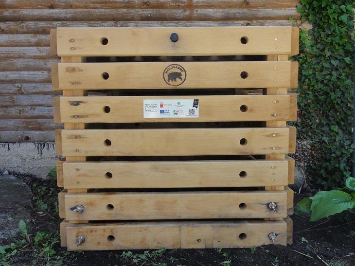 Medovarni kompostnik je lesena struktura, kockaste oblike, z ležeče nameščenimi lesenimi letvicami.